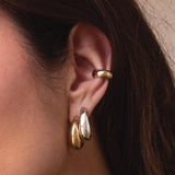 woman wearing a Zoë Chicco Sterling Silver Medium Aura Hoop Earring in her second piercing layered with a 14k Gold Medium Aura Hoop and a Wide Chubby Ear Cuff