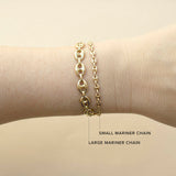 An image of a woman's wrist wearing 2 Zoë Chicco 14k Gold Puffed Mariner Chain Bracelets in Small and Large to show a comparison of size