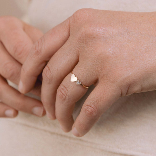 woman's hand wearing a Zoë Chicco 14k Gold Mixed Midi & Itty Bitty Pavé Diamond Heart Ring on her ring finger