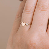 close up shot of a Zoë Chicco 14k Gold Mixed Midi & Itty Bitty Pavé Diamond Heart Ring on a ring finger