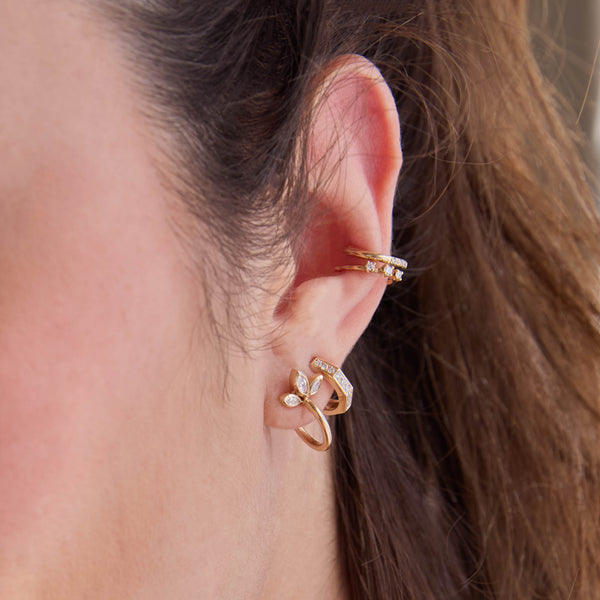 woman's ear wearing a Zoë Chicco 14k Gold Marquise Diamond Fan Huggie Hoop Earring layered with a 14k Pavé Diamond Octagon Huggie Hoop