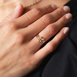 woman's hand with 14k Delicate Diamond Three Stackable Ring Set