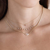 a woman wearing a Zoë Chicco 14k Gold Small Curb Chain Marquise Pink Sapphire Halo Necklace layered with a 14k Marquise Pink Sapphire & Prong Diamond Trio Necklace and a 14k 9 Linked Diamond Trio Necklace