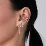 angled close up of a woman's ear wearing a Zoë Chicco 14k Gold Prong Diamond Medium Square Oval Chain Double Drop Earring layered with a 14k Prong Diamond Curved Bar Drop & Jacket Earring in her second piercing