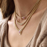 Zoe Chicco 14K Gold Close-up of a person wearing multiple gold necklaces with gemstone pendants.