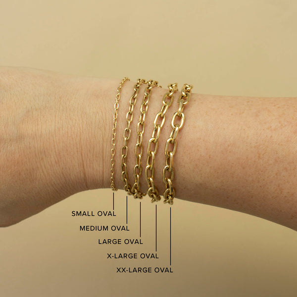 An image of five different widths of Zoë Chicco 14k gold square oval link chain bracelets stacked together to show a comparison of size (small, medium, large, x-large, xx-large)