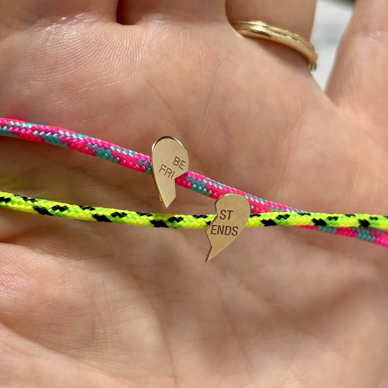 Zoë Chicco 14k Gold Midi Bitty Best Friends Heart Paracord Bracelet Set in Pink Blue and Neon Green Black being held inside the palm of a hand