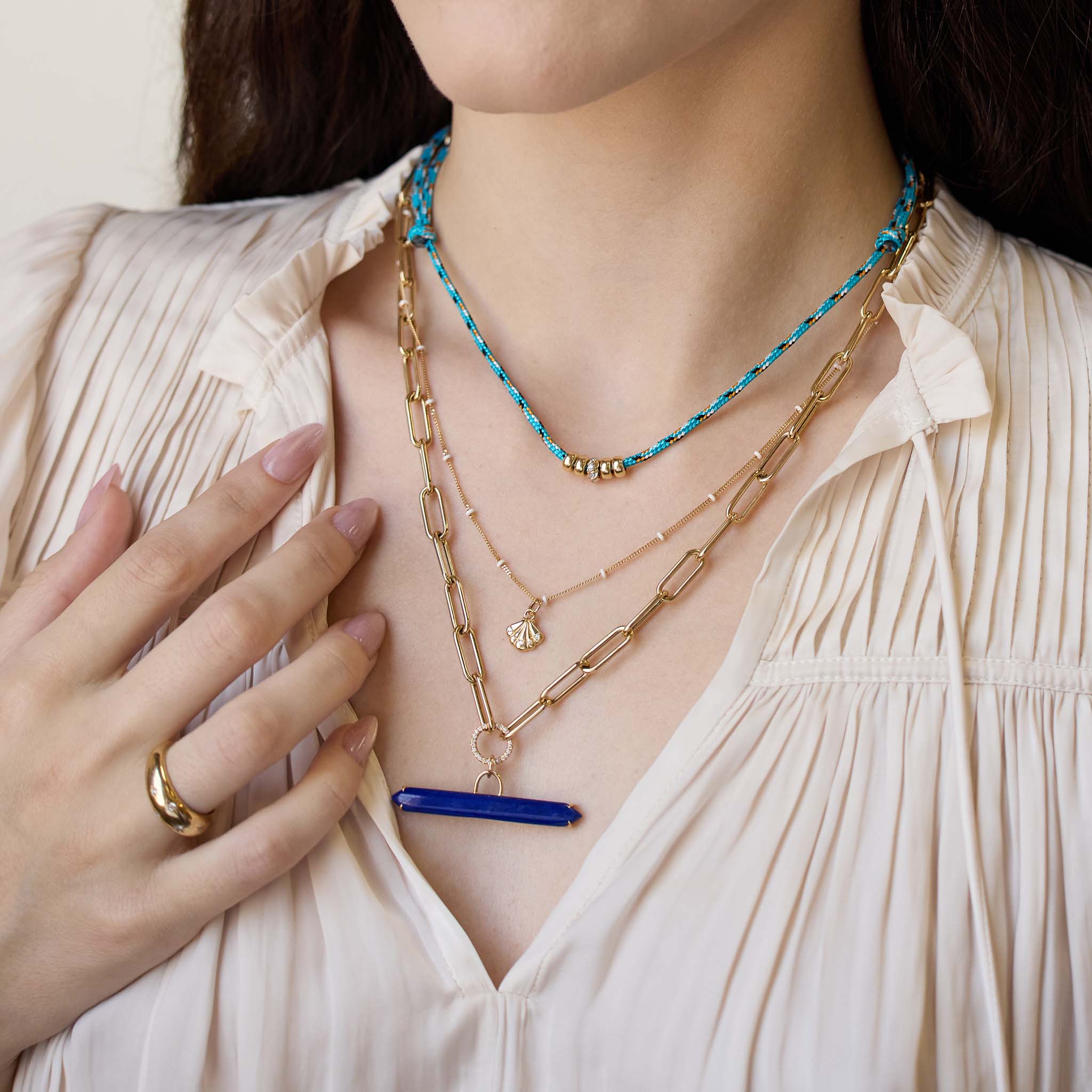 Woman wearing multiple necklaces with a focus on detail featuring 14k Lapis Bar & Pavé Diamond Circle Large Paperclip Chain Necklace