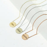 three Zoë Chicco 14k Gold Personalized Small Disc Pendant Necklaces in different gold colors laying against a white background