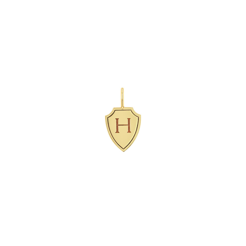Zoe Chicco 14k gold shield-shaped pendant with a letter 'H' on a white background