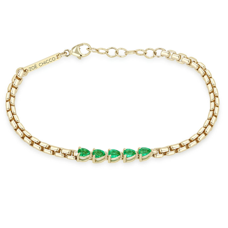 Zoe Chicco 14k gold chain bracelet with five pear-shaped emeralds linked together in the center on a white background