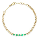 Zoe Chicco 14k gold chain bracelet with five emeralds linked together in the center on a white background