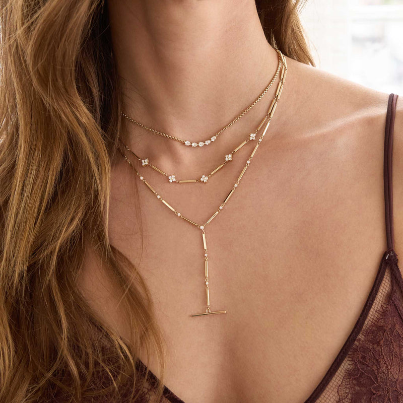 Zoe Chicco 14K Close-up of a woman wearing multiple gold and diamond necklaces 