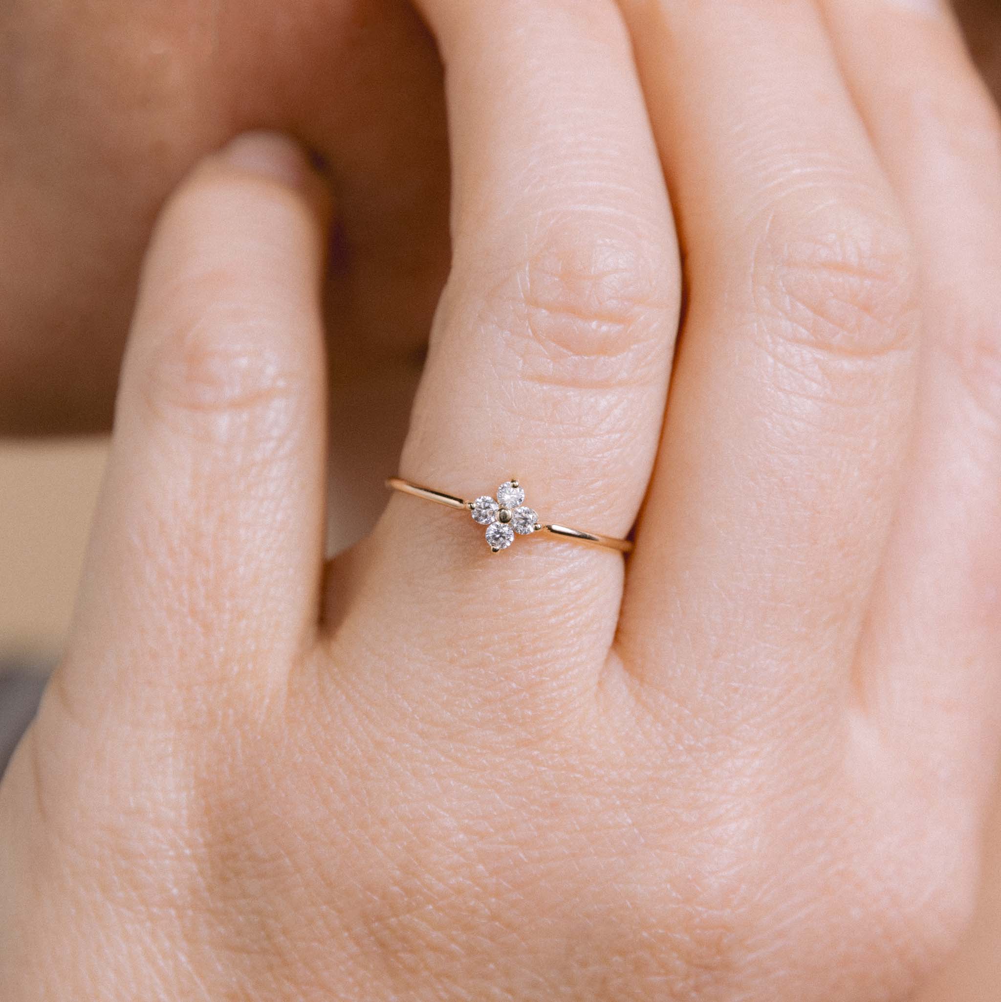 A woman wearing Zoë Chicco 14k Gold Prong Diamond Quad Ring