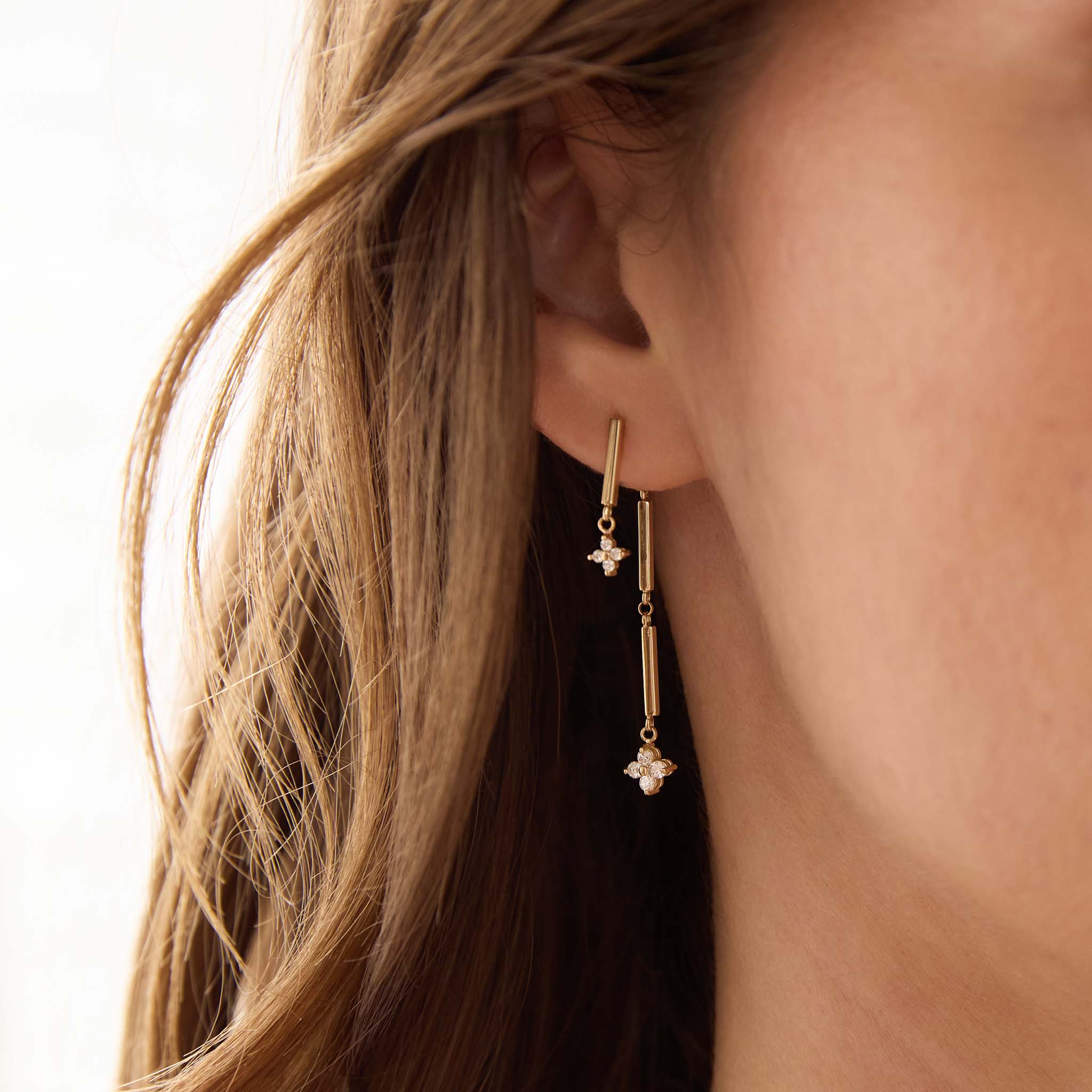 Zoe Chicco 14K woman wearing gold and diamond earrings