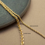 a comparison image of a Zoë Chicco 14k Gold Medium Rope Chain and a Large Rope Chain laying flat against a brown background