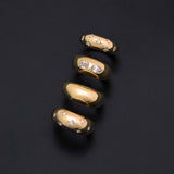 14k Scattered Star Set Diamonds Small Aura Ring, Pear & Emerald Cut Diamond Medium Aura Ring, Plain Medium Aura Ring, and 14k Scattered Star Set Diamonds Medium Aura Ring on a black background
