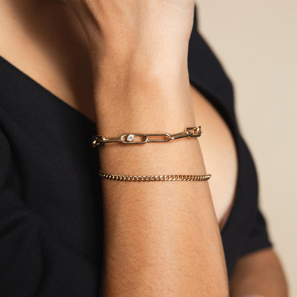 A Zoe Chicco Large paperclip bracelet with prong diamond in the middle and a small curb chain bracelet