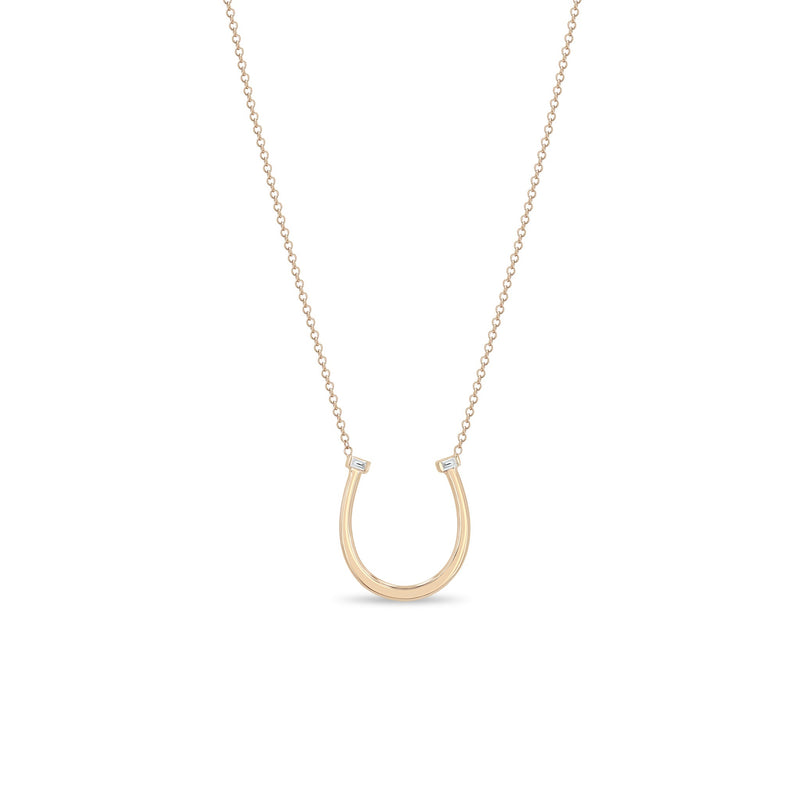 Zoe Chicco 14k rose gold chain necklace with horseshoe pendant and two small baguette diamonds on a white background 