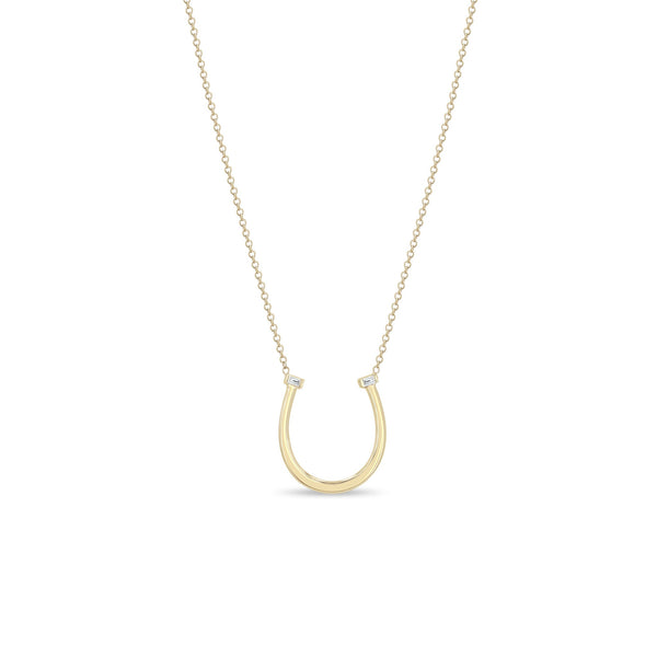 Zoe Chicco 14k gold chain necklace with thin horseshoe shaped pendant with two small baguette diamonds on a white background