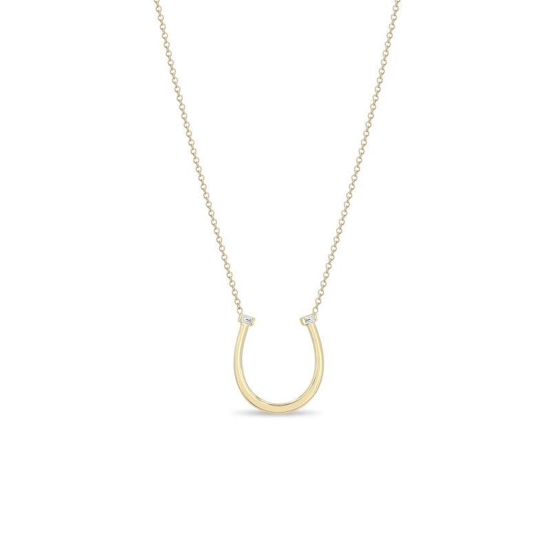Zoe Chicco 14k gold chain necklace with thin horseshoe shaped pendant with two small baguette diamonds on a white background