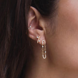 close up of a woman's ear wearing a Zoë Chicco 14k Gold Mixed Prong Diamond J Hook Hoop Earring in her second piercing with a 14k Prong & Pavé Diamond Chain Link Oval Drop Earring