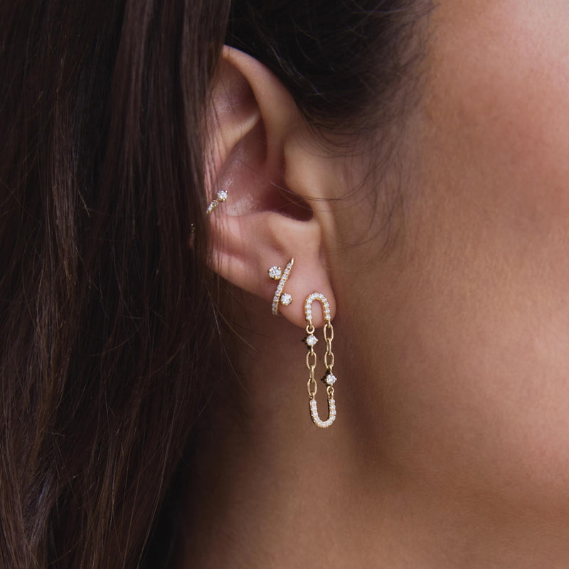 close up of a woman's ear wearing a Zoë Chicco 14k Gold Mixed Prong Diamond Pavé Diamond J Hook Hoop Earring in her second piercing with a 14k Prong & Pavé Diamond Chain Link Oval Drop Earring in her first piercing