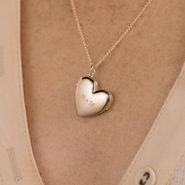 close up of a Zoë Chicco 14k Gold 2 Initial Letters Heart Locket Necklace engraved with an R and M being worn