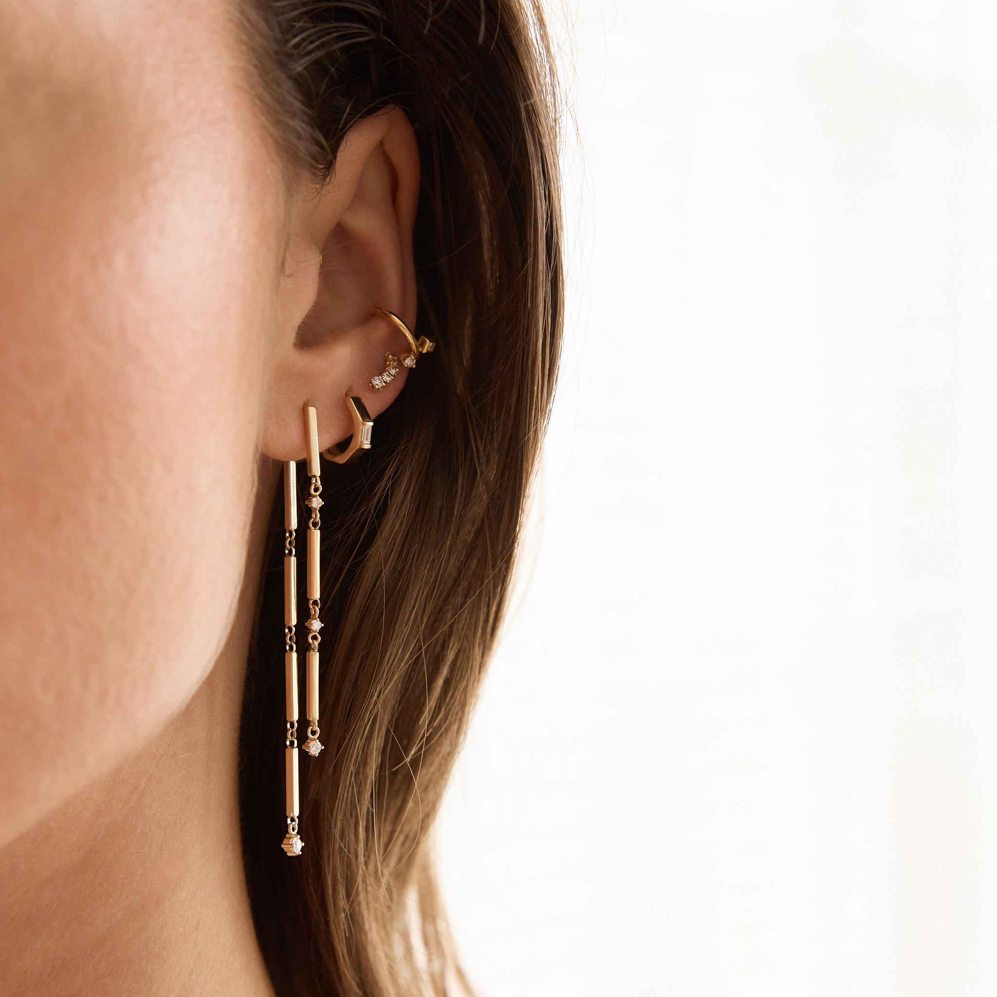 Zoe Chicco 14K woman wearing gold and diamond earrings