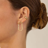Close up of an ear wearing Zoe Chicco 14k snake chain earrings and cuff earrings