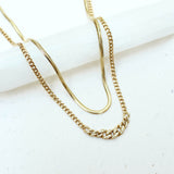 a Zoë Chicco 14k Gold Small Snake Chain Necklace laying flat with a graduated pave diamond curb chain necklace