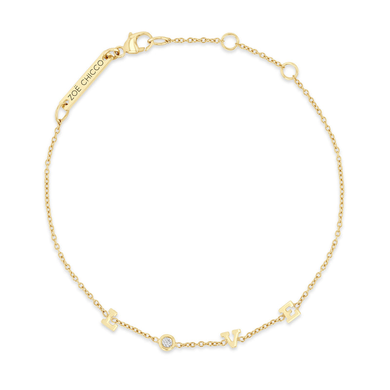 top down view of a Zoë Chicco 14k Gold Itty Bitty LOVE with Floating Diamond Station Bracelet on a white backgroud