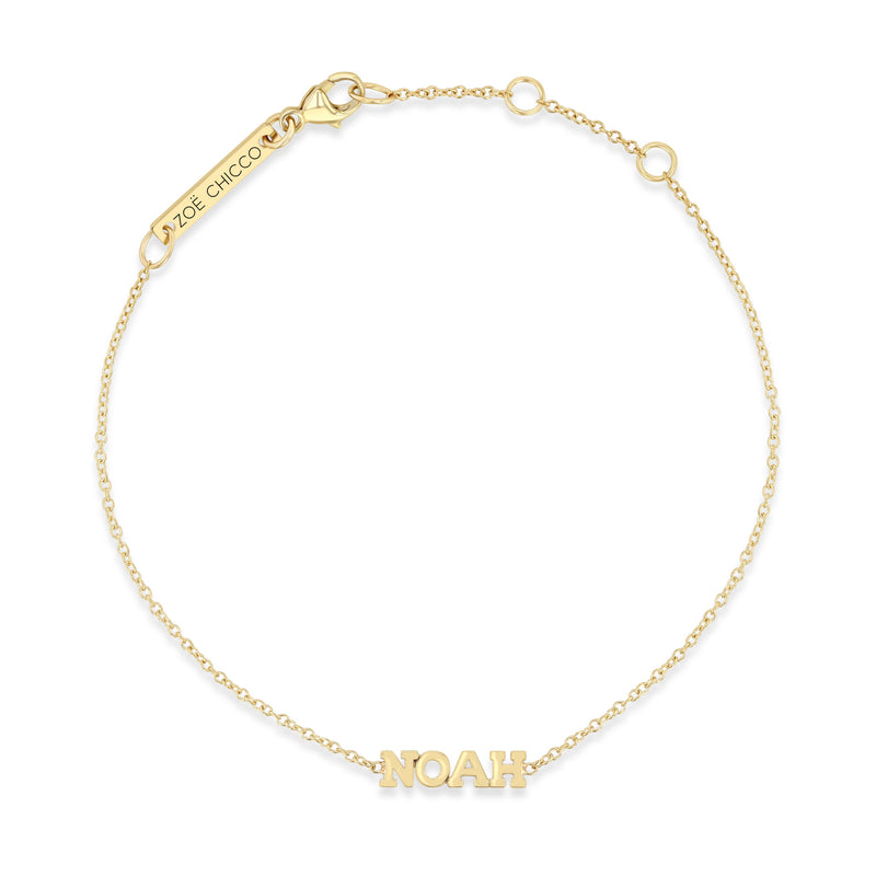 top down view of a Zoë Chicco 14k Gold Custom Itty Bitty Letters Bracelet with the name NOAH