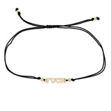 black cord bracelet with 14k gold in the center