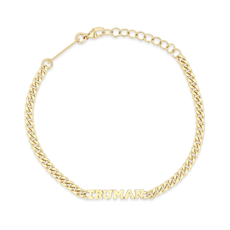 top down view of a Zoë Chicco 14k Gold Custom Itty Bitty Letters Curb Chain Bracelet with the name TRUMAN