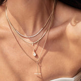 woman's neck wearing a Zoë Chicco 14k Gold One of a Kind Mine Cut Pear Diamond Pendant Necklace layered with three other necklaces