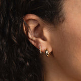woman's ear with 14k Chubby Huggie and Tennis Drop Earring Set