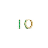 Zoe Chicco14k gold small huggie hoop earrings with emeralds on a white background