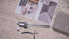 Video of jewelry making tools and 14k gold necklaces and earrings on a stone table background