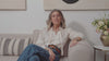 Video of woman sitting on couch with a neutral background, walking around an office space and people designing jewelery