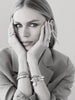 Black and white video of a woman with her hands on her face wearing multiple Zoe Chicco 14k bracelets and rings