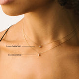 comparison image of Zoë Chicco 14k Gold Single Diamond Bezel Pendant Necklace in two different sizes
