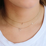 woman in white shirt wearing Zoe Chicco 14kt Midi Bitty Pavé Palm Tree Necklace With Itty Bitty Sun