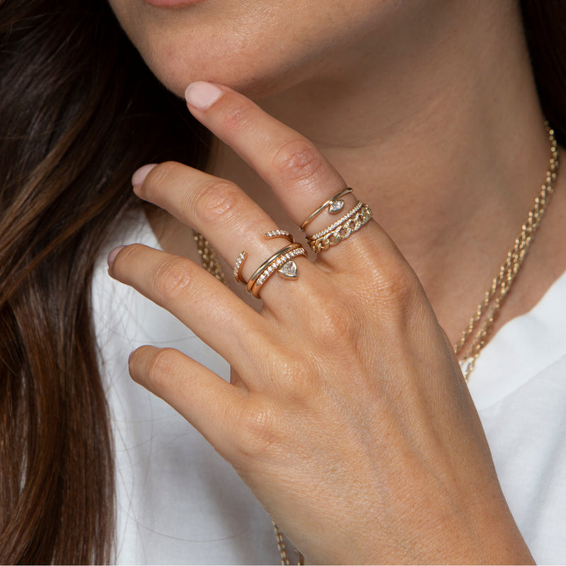 woman's hand wearing Zoë Chicco 14k Gold Trillion Bezel Diamond & Pave Diamond Thick Band Ring