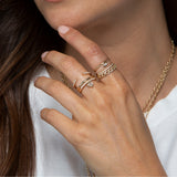 woman in white t-shirt wearing Zoë Chicco 14k Gold Thick Double Open Pavé Diamond Band Ring on her middle finger