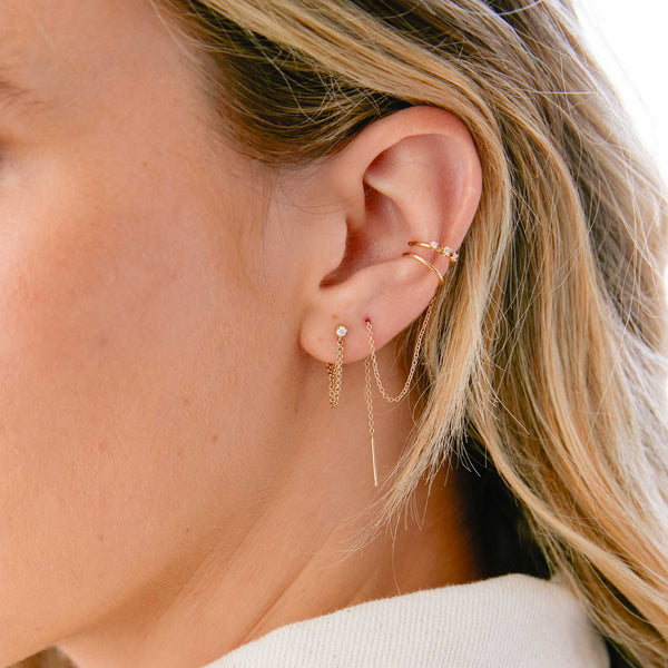 close up of woman's ear wearing a Zoë Chicco 14k Gold Prong Diamond Double Chain Huggie Earring