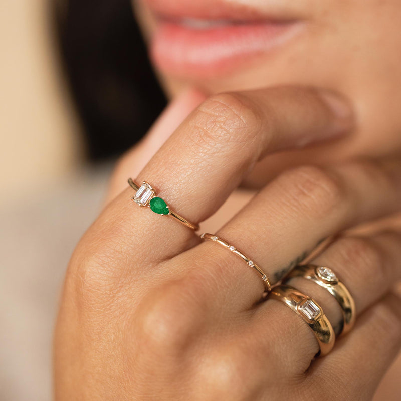 close up of woman's hand wearing a Zoë Chicco 14k Gold Pear Emerald & Emerald Cut Diamond Ring