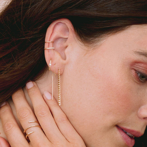 close up of brunette woman's ear wearing Zoë Chicco 14k Gold Small Curb Chain Drop Threader Earrings threaded into two ear holes