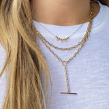 Zoë Chicco 14kt Gold Medium Square Oval Link Chain Faux Toggle Lariat layered with two other gold Zoe Chicco necklaces
