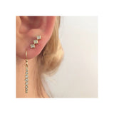 close up of ear wearing Zoë Chicco 14kt Gold Graduated White Diamond Drop Earrings with Princess Diamond Bar Stud Earrings